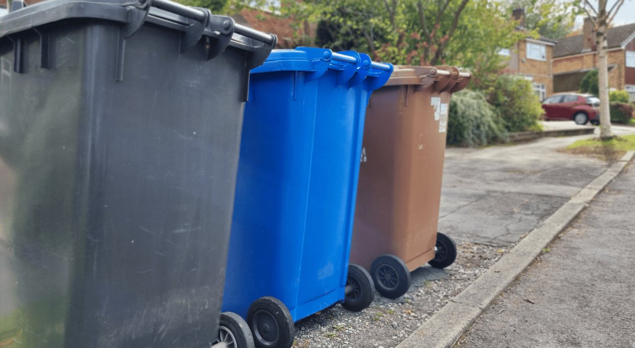Three bins on a street