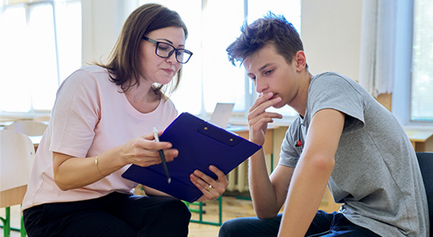 Teen boy in talk with a counsellor
