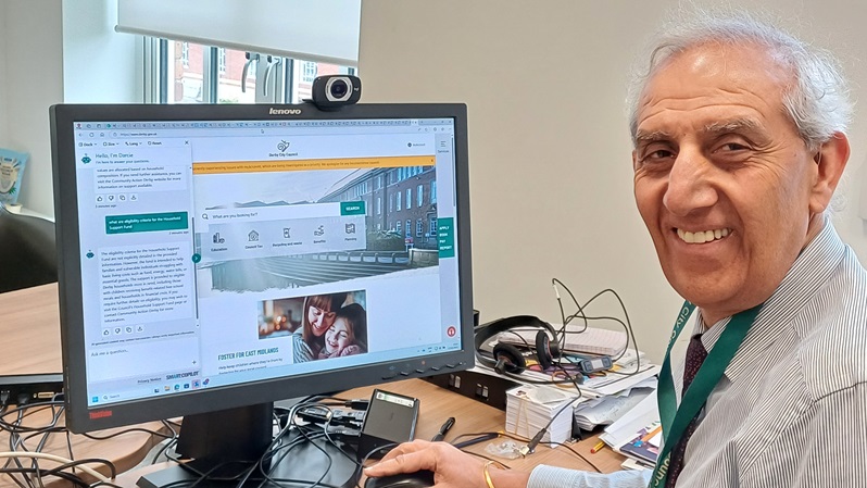 Cllr Dhindsa at a computer showing digital helper Darcie