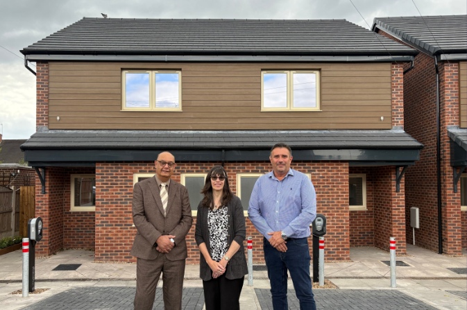 Cllr Khan with Karen Brierly of Derby City Council and James Ward from Mercer Building Solutions outside new affordable homes
