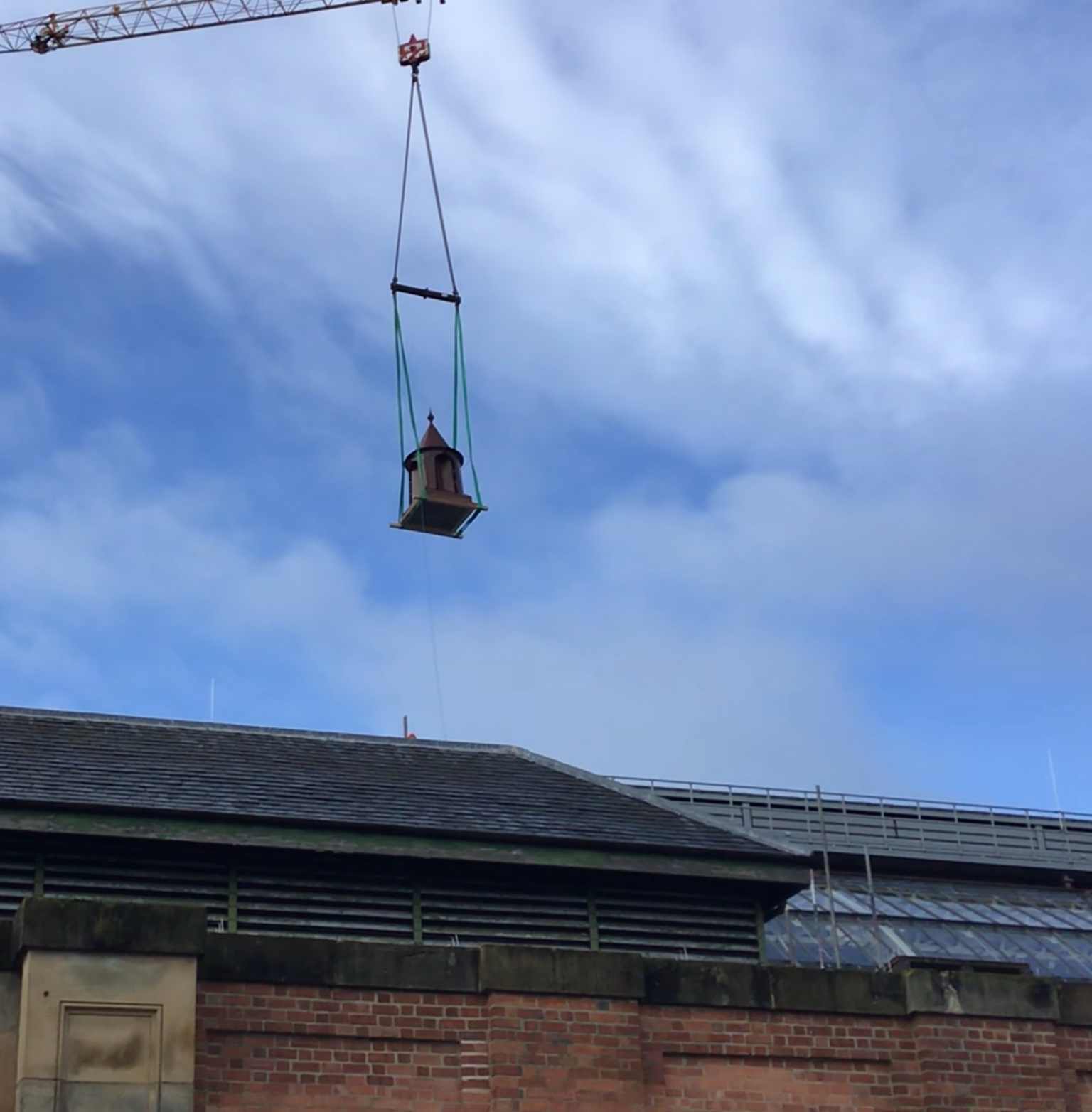 Finial is lowered onto Market Hall roof to complete its restoration. Picture by Wates.