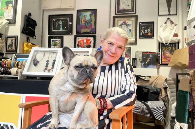 The owner of the fashion stall Eredita & Adesso sitting with her dog