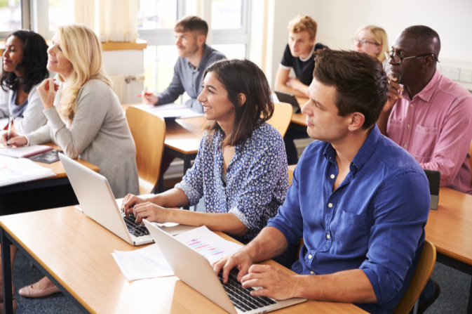 Several adults sitting in a classroom