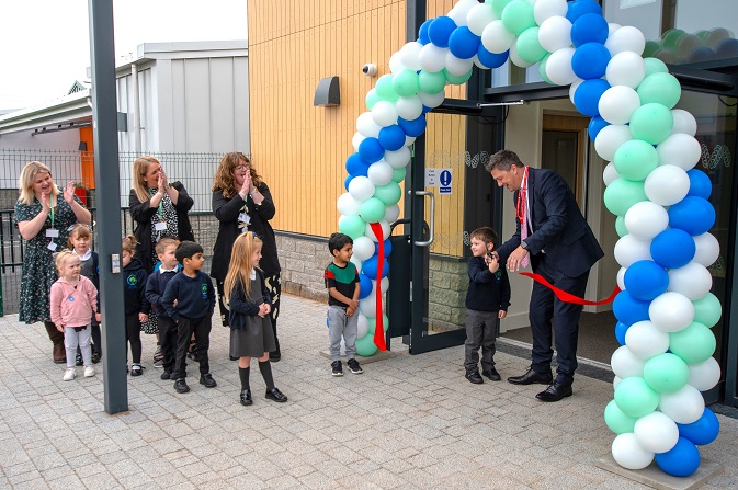 Councillor John Whitby and a pupil cut the ribbon at the opening of Oak Grange Primary School
