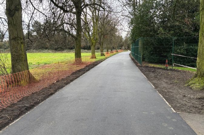 A wide, smooth footpath leading through Alvaston Park