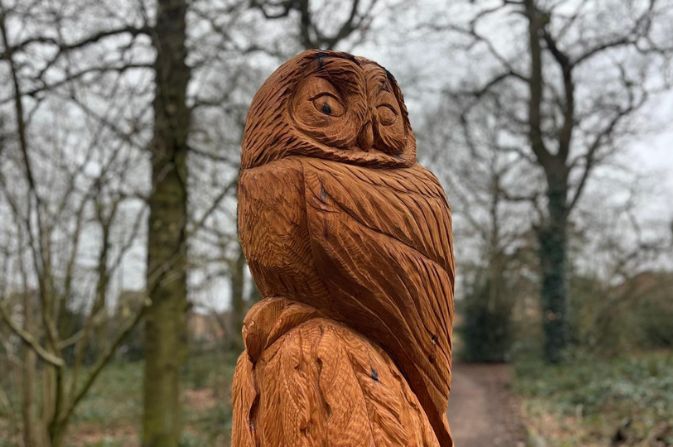 a wooden sculpture of an owl