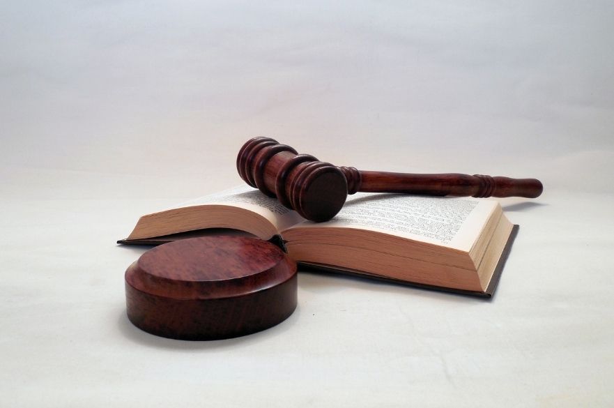 Judges gavel on table with open book 