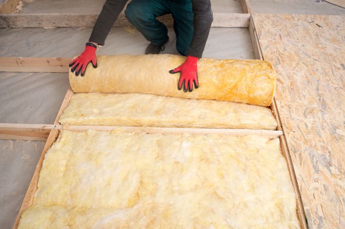 Mineral wool insulation being installed in a loft