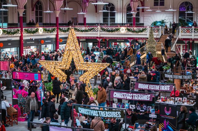 Crowds shopping inside Derby Market Hall decorated for Christmas