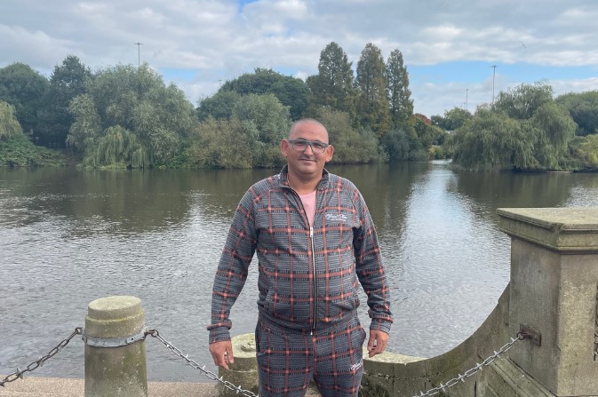 Smiling Martin Balog standing in Derby River Gardens