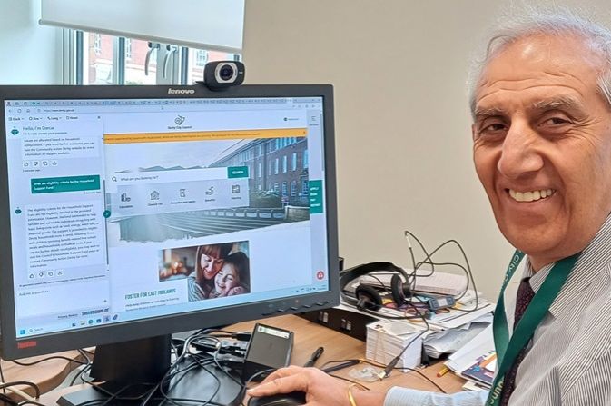 Cllr Dhindsa at a computer showing digital helper Darcie