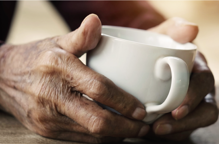A pair of hands holding a mug
