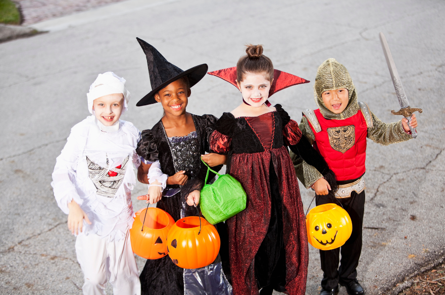 four children dressed up in halloween costumes