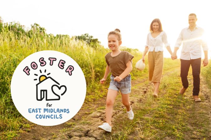 child waling in a field with two adults and the sun is shining