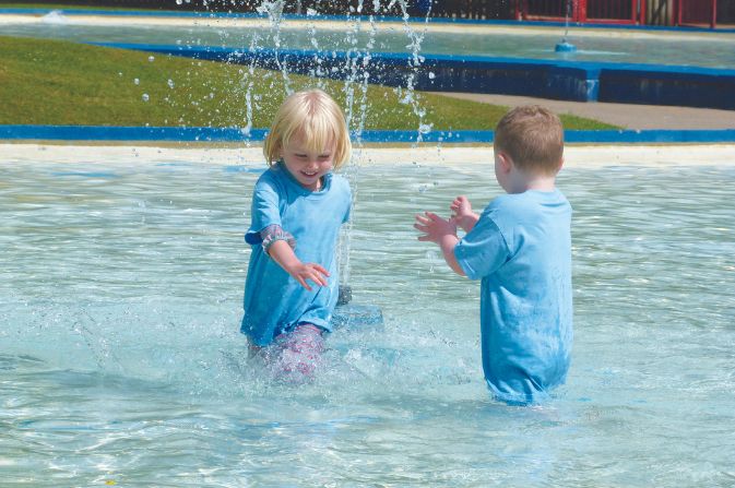 Children playing in markeaton park paddling pool 