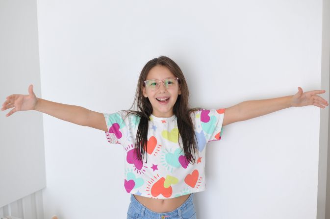 Girl in a heart top stretching out her arms