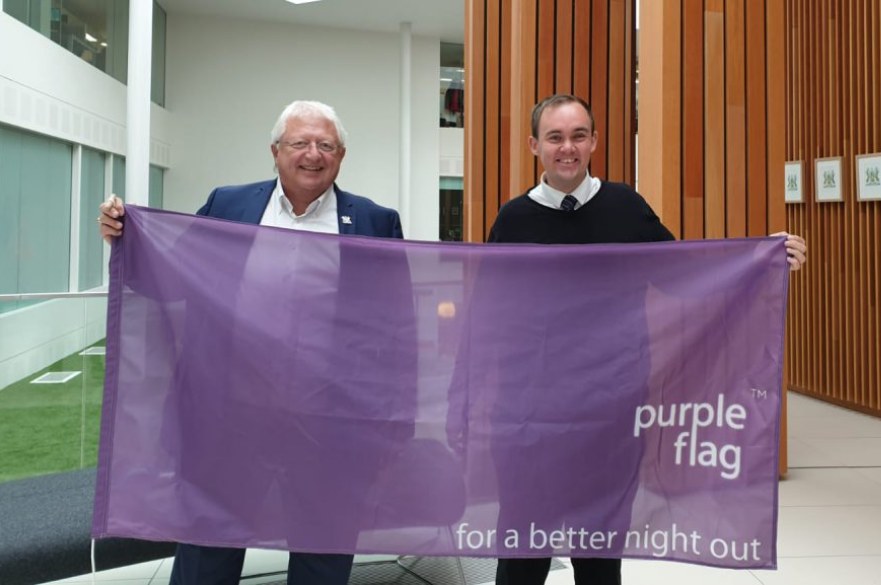 Councillors holding purple flag