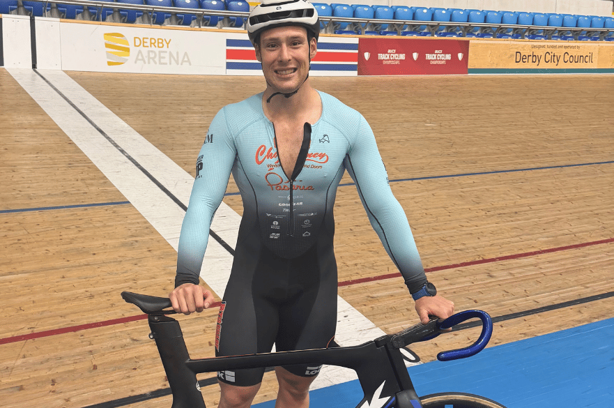 Mateo at Derby Arena stood with his bike on the side of the track.
