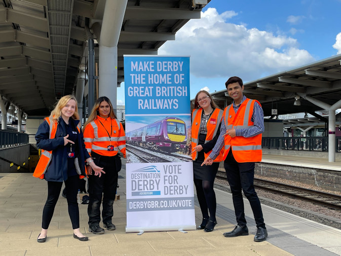 A photo of rail apprentices with a GBR pull-up banner