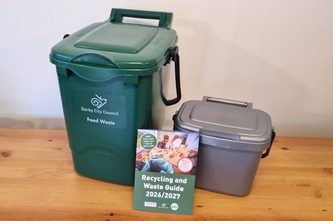 The image shows two food waste containers -the outdoor green 23litre and the grey 5litre kitchen caddy - and the printed guide that comes with the containers